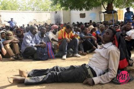 Illegal immigrants who were abandoned by traffickers in a remote desert area wait inside a military base in Dongola town, after being located by Sudanese and Libyan forces, May 3, 2014.   REUTERS/Stringer