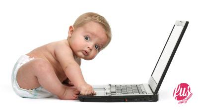 Surprised baby boy using a laptop computer